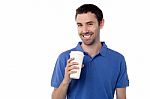 Smiling Man Holding Cold Beverage Stock Photo