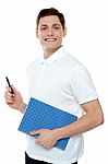 Smiling Man Holding Notebook Stock Photo