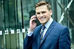 Smiling Man In Suit Talking On Cellphone Stock Photo