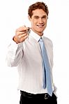 Smiling Man Offering House Key Stock Photo