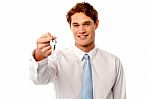 Smiling Man Offering House Key Stock Photo