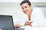 smiling Man Operating Laptop Stock Photo