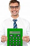 Smiling Man Showing Calculator Stock Photo