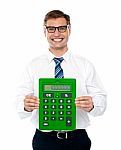  Smiling Man Showing Calculator Stock Photo