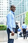 Smiling Man Standing Outside Offices Building Stock Photo