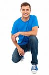 Smiling Man With Kneeling Down Stock Photo