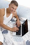 Smiling Man Working On Laptop Stock Photo