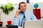 Smiling Manager In Middle Of Business Interactions Stock Photo