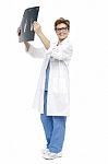 Smiling Middle Aged Doctor Holding Up X-ray Sheet Stock Photo