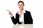 Smiling Professional Lady Pointing Away Stock Photo