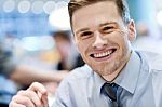 Smiling Relaxed Young Man In Restaurant Stock Photo