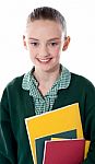 Smiling School Girl Holding Books Stock Photo