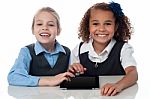 Smiling School Girls Playing On Touchpad Stock Photo