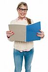 Smiling Student Reading From Her Note Book Stock Photo