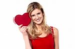 Smiling Teen Girl Showing Heart Shape Gift To Camera Stock Photo