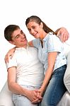 Smiling Teenage Couple Sitting Stock Photo