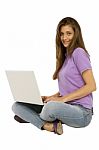 Smiling Teenage Girl Using Laptop Stock Photo