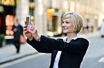 Smiling Woman Capturing A Self Shot Stock Photo