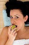 Smiling Woman Eating Apple Stock Photo