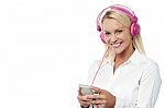 Smiling Woman Enjoying Music With Her Mobile Phone Stock Photo