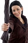 Smiling Woman Giving Umbrella Stock Photo