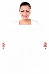 Smiling Woman Holding Blank White Ad Board Stock Photo