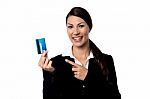 Smiling Woman Holding Up Credit Card Stock Photo