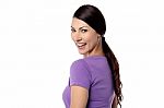 Smiling Woman Looking Over Shoulder Stock Photo