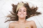 Smiling Woman Lying In Bed Stock Photo