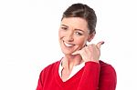 Smiling Woman Making A Call Me Gesture Stock Photo