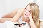 Smiling Woman On Bed Stock Photo