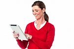 Smiling Woman Operating Touch Pad Device Stock Photo