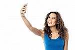 Smiling Woman Taking Photo Of Herself Stock Photo