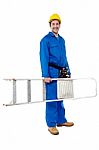 Smiling Worker Carrying A Ladder Stock Photo