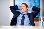 Smiling Young Businessman Thinking Something Stock Photo