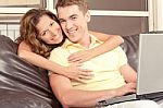 Smiling Young Couple With Laptop Stock Photo