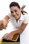 Smiling Young Girl Giving Pencil Stock Photo