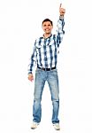 Smiling Young Guy Pointing Upwards Stock Photo