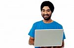 Smiling Young Guy Using His Laptop Stock Photo