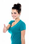 Smiling Young Lady Showing Thumb Up Stock Photo