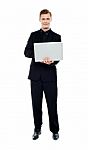 Smiling Young Man Holding Laptop Stock Photo