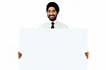 Smiling Young Man Holding White Sign Board Stock Photo