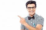 Smiling Young  Man Pointing Away Stock Photo