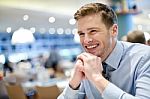 Smiling Young Man Relaxing In A Cafe Stock Photo