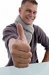 Smiling Young Man Showing Thumb Up Stock Photo