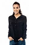 Smiling Young Woman With Hand In Pocket Stock Photo