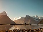 Snowcaped Mountains With A Lake Glassy Shore Stock Photo