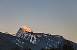 Snowy Mountain Tops In The Blue Sky Sun Stock Photo