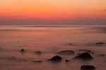 Soft Waves On A Rocky Beach In The Evening Stock Photo