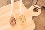 Spoon Of Flax Seed On Wooden Table Stock Photo